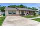 Charming single-story home featuring stone accents, neutral stucco, updated windows, and a spacious driveway at 466 Leland Dr, Deltona, FL 32725