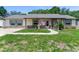 Inviting single-story home with well-maintained lawn, stone accents, and cozy front entrance at 466 Leland Dr, Deltona, FL 32725