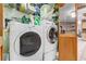 Laundry room includes a washer, dryer, and plenty of storage space at 466 Leland Dr, Deltona, FL 32725