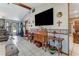 Open living area showcases a large TV, vintage furniture, and decorative accents throughout the space at 466 Leland Dr, Deltona, FL 32725