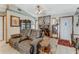 Cozy living room features a stone fireplace, unique decor, comfortable seating, and neutral tile floors at 466 Leland Dr, Deltona, FL 32725