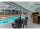 Seating area next to a pool, creating a serene and inviting outdoor space for relaxation and gatherings at 466 Leland Dr, Deltona, FL 32725