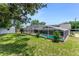 Aerial backyard view featuring the pool enclosure, shed, and green space, blending relaxation with utility at 466 Leland Dr, Deltona, FL 32725