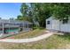 Backyard with a screened pool and shed, offering both relaxation and storage space at 466 Leland Dr, Deltona, FL 32725