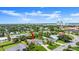 Aerial view of the home, neighborhood, and city in the background, with red arrow showing property location at 1026 Bel Aire Dr, Daytona Beach, FL 32118