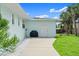 The backyard features a grill, stone bench seating, and mature palm trees at 1026 Bel Aire Dr, Daytona Beach, FL 32118