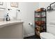 Tastefully decorated bathroom with a granite sink, modern accents, and a dark tiled floor at 1026 Bel Aire Dr, Daytona Beach, FL 32118