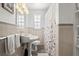 Bathroom featuring pedestal sink, toilet, and curtained shower at 1026 Bel Aire Dr, Daytona Beach, FL 32118