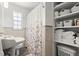 Well-lit bathroom featuring vintage tile, ample storage, and a shower with curtain at 1026 Bel Aire Dr, Daytona Beach, FL 32118
