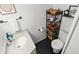 Bright bathroom with unique dark tile flooring, modern countertop, and decorative shelving at 1026 Bel Aire Dr, Daytona Beach, FL 32118