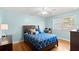 Charming bedroom with light blue walls, hardwood floors and blue patterned bedding at 1026 Bel Aire Dr, Daytona Beach, FL 32118