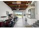 Spacious garage featuring exposed rafters, a motorcycle, and room for creative pursuits at 1026 Bel Aire Dr, Daytona Beach, FL 32118