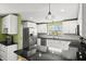An open kitchen featuring sleek stainless steel appliances, white cabinets, and a black countertop at 1026 Bel Aire Dr, Daytona Beach, FL 32118