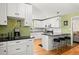 The kitchen is designed with stainless steel appliances, black countertops, white cabinetry and breakfast bar seating at 1026 Bel Aire Dr, Daytona Beach, FL 32118