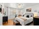 Cozy main bedroom boasts a ceiling fan, accent rug, and abundant natural light from the window at 1026 Bel Aire Dr, Daytona Beach, FL 32118