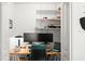 Bright office space with dual monitors, floating shelves, and a comfortable desk at 1026 Bel Aire Dr, Daytona Beach, FL 32118