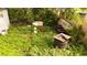 Overgrown back yard with discarded tires, a boat, and other junk at 1131 Martha Dr, Daytona Beach, FL 32114