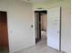View of a bright, unfinished bedroom featuring an open closet space and neutral walls at 1131 Martha Dr, Daytona Beach, FL 32114