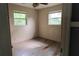 Bright bedroom with two windows, ceiling fan, and ample natural light at 1131 Martha Dr, Daytona Beach, FL 32114