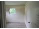 Bedroom featuring a window offering natural light and neutral-toned walls at 1131 Martha Dr, Daytona Beach, FL 32114