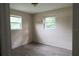 Bright bedroom with neutral walls, two windows, and ample natural light at 1131 Martha Dr, Daytona Beach, FL 32114