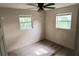 Bedroom with two windows, offering plenty of natural light and a ceiling fan at 1131 Martha Dr, Daytona Beach, FL 32114