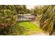 Single-story home featuring fresh paint, a tidy front yard, a new roof, and wooden garage doors at 1131 Martha Dr, Daytona Beach, FL 32114