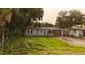 Single-story home featuring fresh paint, a tidy front yard, a new roof, and wooden garage doors at 1131 Martha Dr, Daytona Beach, FL 32114