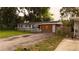 Single-story home featuring fresh paint, a tidy front yard, and wooden garage doors at 1131 Martha Dr, Daytona Beach, FL 32114