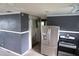 Kitchen with stainless steel appliances and gray walls with white trim, offering modern appeal at 1131 Martha Dr, Daytona Beach, FL 32114