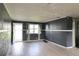 View of the living room with dark gray walls, white trim, and light-colored flooring at 1131 Martha Dr, Daytona Beach, FL 32114