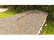 Aerial view of a home's asphalt shingle roof with leaf litter, surrounded by grass and trees at 1131 Martha Dr, Daytona Beach, FL 32114