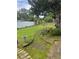 Spacious backyard with green grass, a white fence and manicured landscaping at 1218 Daytona Ave, Daytona Beach, FL 32117