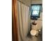 Bathroom featuring a window, a shower curtain, and a toilet at 1218 Daytona Ave, Daytona Beach, FL 32117