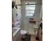 Bright bathroom with glass shower, white vanity and linen cabinet at 1218 Daytona Ave, Daytona Beach, FL 32117