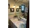 Bathroom vanity with marble countertop, pale green walls and blue tile backsplash at 1218 Daytona Ave, Daytona Beach, FL 32117
