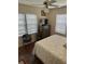 Cozy bedroom featuring hardwood floors, ceiling fan, and bright, natural light at 1218 Daytona Ave, Daytona Beach, FL 32117