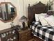 Charming bedroom featuring antique furniture, decorative mirror, and patterned bedding at 1218 Daytona Ave, Daytona Beach, FL 32117