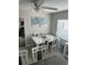 Bright dining room with a white table, gray chairs, and modern art at 1218 Daytona Ave, Daytona Beach, FL 32117