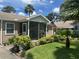 Charming home featuring a screened front porch and well-maintained landscaping at 1218 Daytona Ave, Daytona Beach, FL 32117