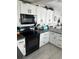 Modern kitchen featuring white cabinetry and black appliances at 1218 Daytona Ave, Daytona Beach, FL 32117