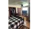 Comfortable bedroom featuring a black and white bed set and a large wardrobe at 1218 Daytona Ave, Daytona Beach, FL 32117