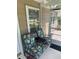 Screened porch with seating at 1218 Daytona Ave, Daytona Beach, FL 32117