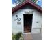 Charming shed featuring a white exterior, unique decorations, and an open doorway to organized interior storage at 1218 Daytona Ave, Daytona Beach, FL 32117