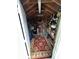 Interior view of a well-organized shed with shelves, tools, and a red accent rug for comfort at 1218 Daytona Ave, Daytona Beach, FL 32117