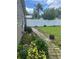 Side yard with a white fence, a brick paver pathway, and lush landscaping at 1218 Daytona Ave, Daytona Beach, FL 32117
