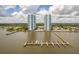 Stunning aerial view of waterfront condos, pier, and docks under a blue sky at 231 Riverside Dr # 1602, Holly Hill, FL 32117