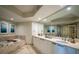 Marble bathroom featuring a large soaking tub, glass shower, and double vanity at 231 Riverside Dr # 1602, Holly Hill, FL 32117