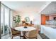 Open-concept dining space with natural light, modern furniture and view of kitchen at 231 Riverside Dr # 1602, Holly Hill, FL 32117