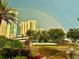 Exterior of Marina Grande condo buildings with a rainbow in the background at 231 Riverside Dr # 1602, Holly Hill, FL 32117